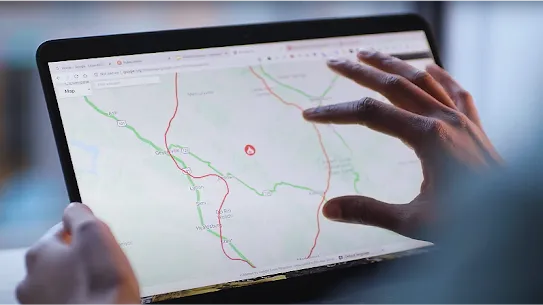 Close up of someone's hand touching a tablet screen, zooming in on a map