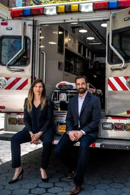 People sitting in the back of an ambulance